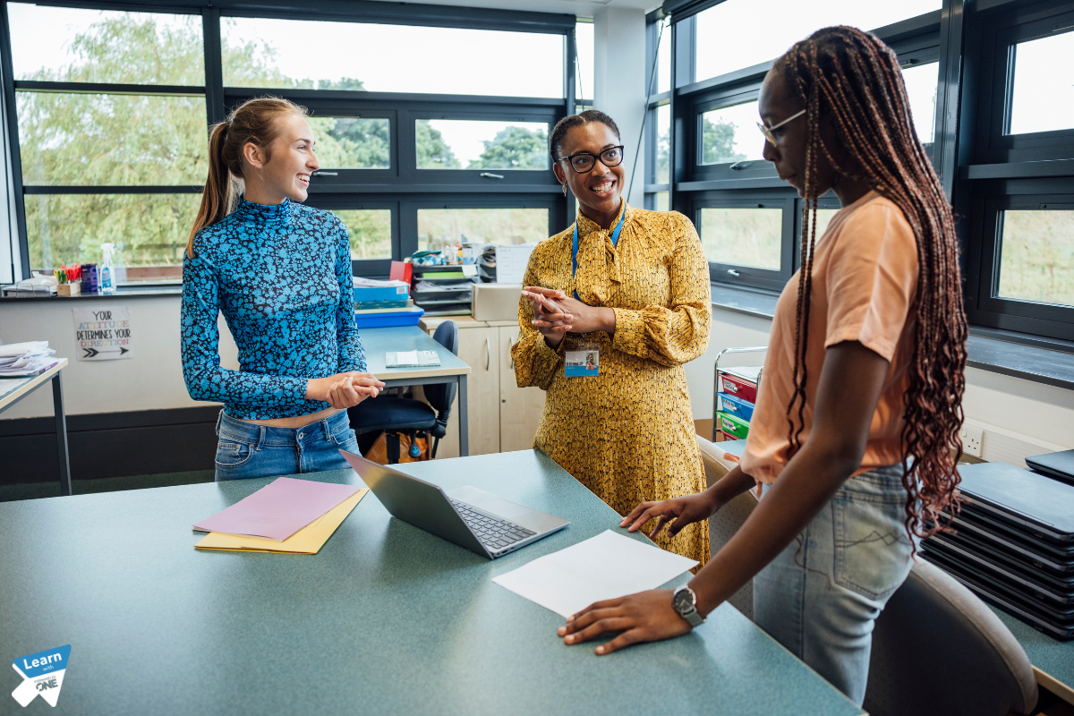 3 women talking in school around a table